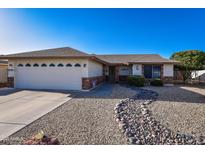 Charming single-story home featuring a low-maintenance landscape, complemented by neutral tones and a two-car garage at 7916 E Naranja Ave, Mesa, AZ 85209