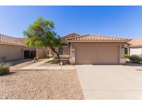 Single Gathering home featuring a two-car garage, red tile roof, and desert landscaping at 1058 W Swan Dr, Chandler, AZ 85286