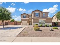Two-story home features a two-car garage, neutral stucco, desert landscaping, and a concrete driveway at 11129 E Reginald Ave, Mesa, AZ 85212