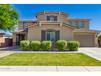 Charming two-story home with a well-manicured lawn and lovely curb appeal on a bright, sunny day at 1217 W Fever Tree Ave, San Tan Valley, AZ 85140