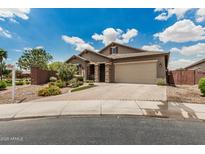 Beautiful single story home with a brick driveway and stone pillars at 1228 W Snowbell Ave, Queen Creek, AZ 85140