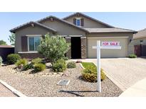 Charming single-story home with a well-maintained landscape, desert rock, and a For Sale sign at 1228 W Snowbell Ave, Queen Creek, AZ 85140