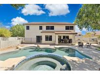 Beautiful backyard features a sparkling pool and spa, perfect for relaxing and entertaining at 12748 N 57Th Dr, Glendale, AZ 85304