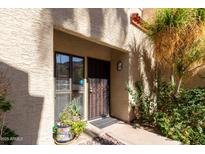 Charming condo exterior with a decorative metal security door and a lush potted plant at 1401 E Puget Ave # 4, Phoenix, AZ 85020