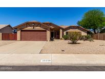 Charming single-story home featuring low-maintenance landscaping and a spacious driveway leading to a two-car garage at 15256 N 62Nd Ave, Glendale, AZ 85306