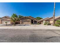 Charming single-story home with a well-manicured lawn and a two-car garage at 16242 W Maui Ln, Surprise, AZ 85379