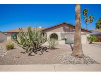 Charming single story home featuring desert landscaping, a two-car garage and arched entryway windows at 17244 N 36Th Ln, Glendale, AZ 85308