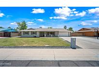 Charming single-story home featuring a well-manicured lawn, gray brick, and a classic suburban appeal at 1831 W Seldon Ln, Phoenix, AZ 85021