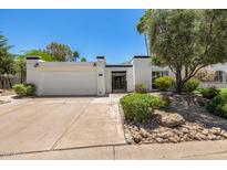 Charming single-story home with a two-car garage, desert landscaping, and secure gated front entry at 19 E Boca Raton Rd, Phoenix, AZ 85022