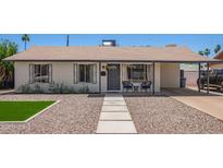 Charming single story home featuring neutral paint, desert landscaping, and a covered porch with seating at 1937 E Loyola Dr, Tempe, AZ 85282
