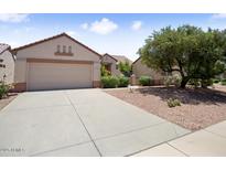 Charming single-story home with desert landscaping, a two car garage and a neutral color palette at 20007 N Siesta Rock Dr, Surprise, AZ 85374