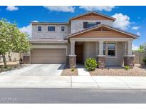 Charming two-story home boasts a well-maintained yard and inviting front porch with stone accents at 2741 S Gordon --, Mesa, AZ 85209