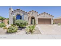 Charming single-story home boasting a stucco exterior, desert landscaping, and a tile roof at 27413 W Tonopah Dr, Buckeye, AZ 85396