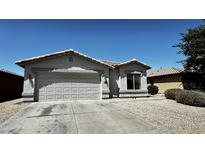 Charming single-story home with a two-car garage, desert landscaping and a tile roof at 43890 W Bedford Dr, Maricopa, AZ 85138