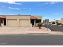 Charming single-story home with a well-maintained front yard and two-car garage at 440 S Parkcrest -- # 22, Mesa, AZ 85206