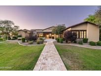 Stunning single-story home with beautiful landscaping and a paver walkway leading to the front door at 4610 E Meadowview Dr, Gilbert, AZ 85298