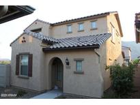 Charming two-story home featuring an arched entryway, tile roof, and neutral stucco exterior at 5345 W Marcus Dr, Phoenix, AZ 85083
