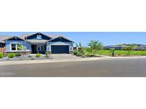 Beautiful single-Gathering home with blue accents, a manicured front yard and a two car garage in a Gathering-friendly neighborhood at 5614 W Saint Moritz Ln, Glendale, AZ 85306