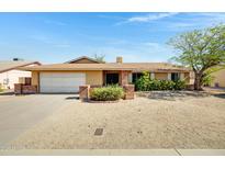 Charming single-story home featuring a brick facade and a low-maintenance front yard at 6128 W Columbine Dr, Glendale, AZ 85304