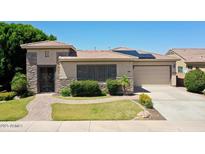 Charming single-story home featuring desert landscaping, stone accents, and a two-car garage at 6886 W Mazatzal Dr, Peoria, AZ 85383