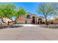 Charming two-story home features a three-car garage, mature landscaping, and a welcoming entrance at 7421 S 25Th Ln, Phoenix, AZ 85041