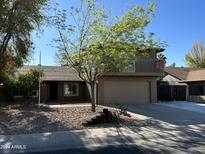Two-story home with a two-car garage and a balcony above in a suburban neighborhood at 8117 W Dreyfus Dr, Peoria, AZ 85381