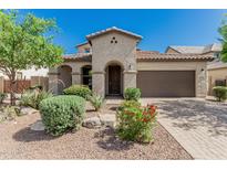 Beautiful single-Gathering home featuring desert landscaping and an arched entryway at 9747 W Sands Dr, Peoria, AZ 85383