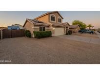 Inviting two-story home featuring desert landscaping, solar panels, and a spacious driveway at 10822 W Quail Ave, Peoria, AZ 85373