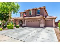Expansive home with a wide driveway, three-car garage, and a well-maintained lawn creates a striking curb appeal at 13123 W Cottontail Ln, Peoria, AZ 85383
