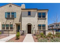 Charming townhome exterior features a private patio and neutral stucco facade at 1849 E Chelsea Ln # 107, Gilbert, AZ 85295