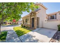 Charming two-story home featuring a stone-accented facade, lush lawn, and inviting curb appeal at 1851 E Ellis St, Phoenix, AZ 85042