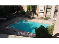 Community pool with clear blue water and mature landscaping around the apartment building at 200 E Southern Ave # 363, Tempe, AZ 85282