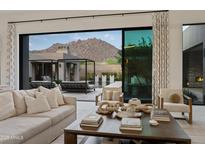 Bright living room featuring neutral decor, modern furnishings, and a seamless indoor-outdoor flow at 24863 N 103Rd Way, Scottsdale, AZ 85255