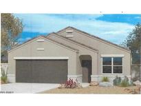 Charming single-story home featuring neutral colors, a two-car garage and simple desert landscaping at 25602 W Coles Rd, Buckeye, AZ 85326