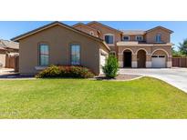 Charming two-story home featuring a well-maintained lawn and appealing desert landscaping at 3065 E Harvard Ave, Gilbert, AZ 85234