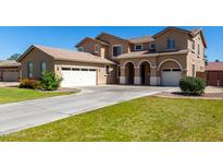 Attractive stucco home boasting multiple garages and a spacious driveway at 3065 E Harvard Ave, Gilbert, AZ 85234