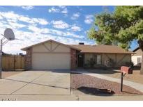 Charming single-story home with brick accents, a two-car garage, and a well-maintained front yard at 3121 W Laurie Ln, Phoenix, AZ 85051