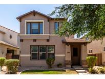 Charming two-story home features a covered entrance and well-maintained landscaping at 3449 E Sheffield Rd, Gilbert, AZ 85296