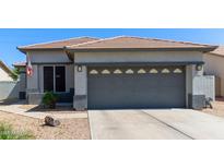 Charming single-story home featuring a gray two-car garage and a well-maintained desert landscape at 3668 E Derringer Way, Gilbert, AZ 85297