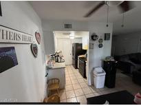 Galley style kitchen features tile floors, white cabinets and a full appliance package in a cozy layout at 4002 W Palomino Rd, Phoenix, AZ 85019