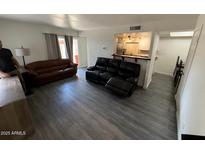 Spacious living room featuring hardwood floors and comfortable seating arrangements at 4111 W Reade Ave, Phoenix, AZ 85019