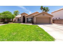 Charming single-story home featuring a lush green lawn and a two-car garage at 423 W Century Ct, Gilbert, AZ 85233
