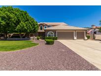 Beautiful single-Gathering home with a three-car garage and mature landscaping at 4648 W Misty Willow Ln, Glendale, AZ 85310