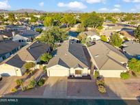 Stunning aerial view of a well-maintained home in a quiet neighborhood with mature trees and desert landscaping at 4725 E Brown Rd # 13, Mesa, AZ 85205