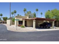 Inviting home with a carport and low maintenance desert landscaping, nestled in a charming neighborhood with mature palm trees at 520 S Sand Verbena Way, Mesa, AZ 85208