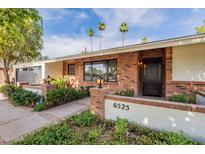 Charming single-story brick home featuring a well-manicured front yard and a welcoming entrance at 6525 N 3Rd St, Phoenix, AZ 85012