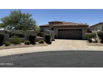 Charming single-story home featuring a tile roof, desert landscaping, and a two-car garage at 7979 E Princess Dr # 8, Scottsdale, AZ 85255