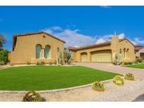 Charming single-story home with stucco and tile roof, complimented by desert landscaping and manicured lawn at 8298 E Tailfeather Dr, Scottsdale, AZ 85255