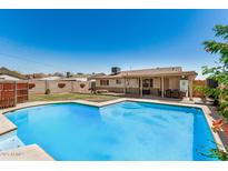 Expansive backyard oasis with a sparkling pool, covered patio, and ample space for outdoor fun at 844 E Ruth Ave, Phoenix, AZ 85020