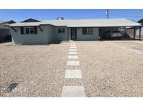 Charming single-story home with a well-manicured, desert-landscaped front yard and covered parking at 1010 W 13Th St, Tempe, AZ 85281